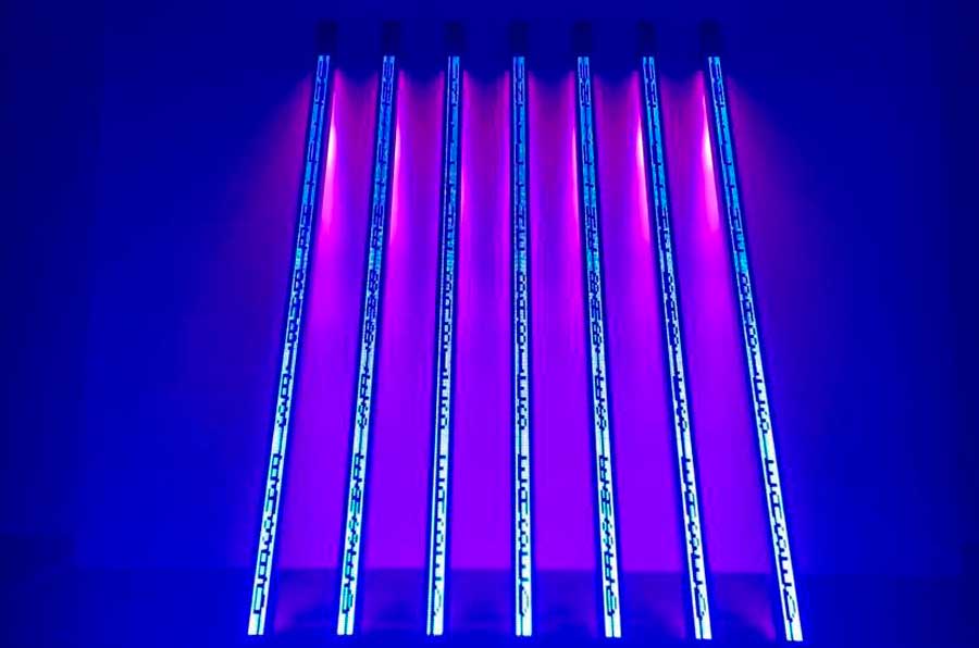 A bright neon art sign inside the Tate Modern Lates
