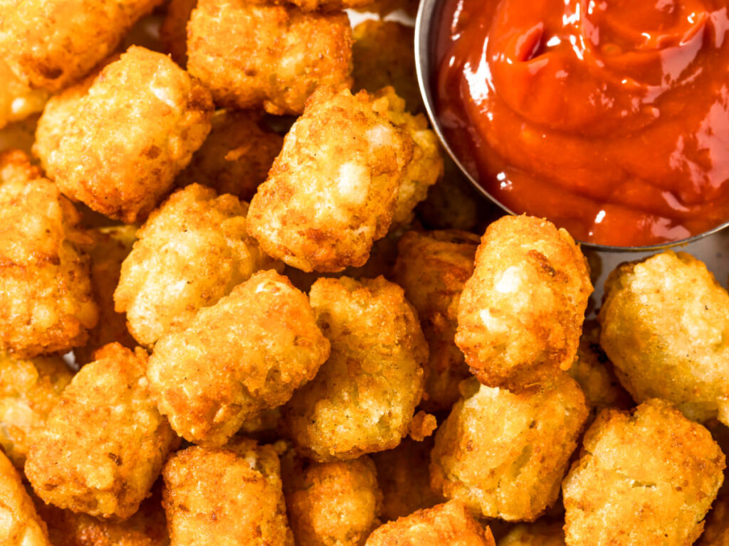 Closeup view of the tater tots with ketchup