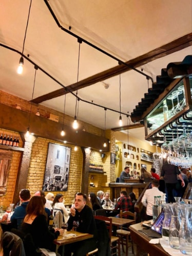 View of the crowd dining inside the Taverna Trastevere