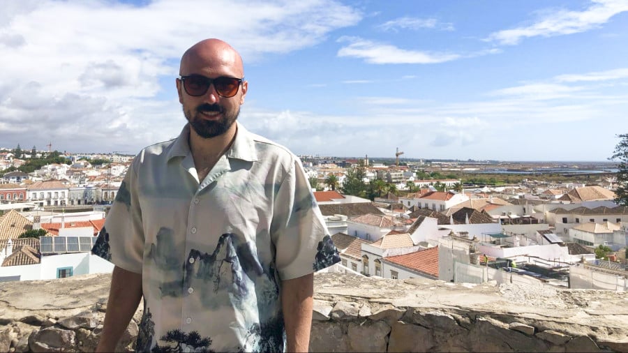 The author Betty Booker's husband posing at the viewpoint with the overlooking city in the background