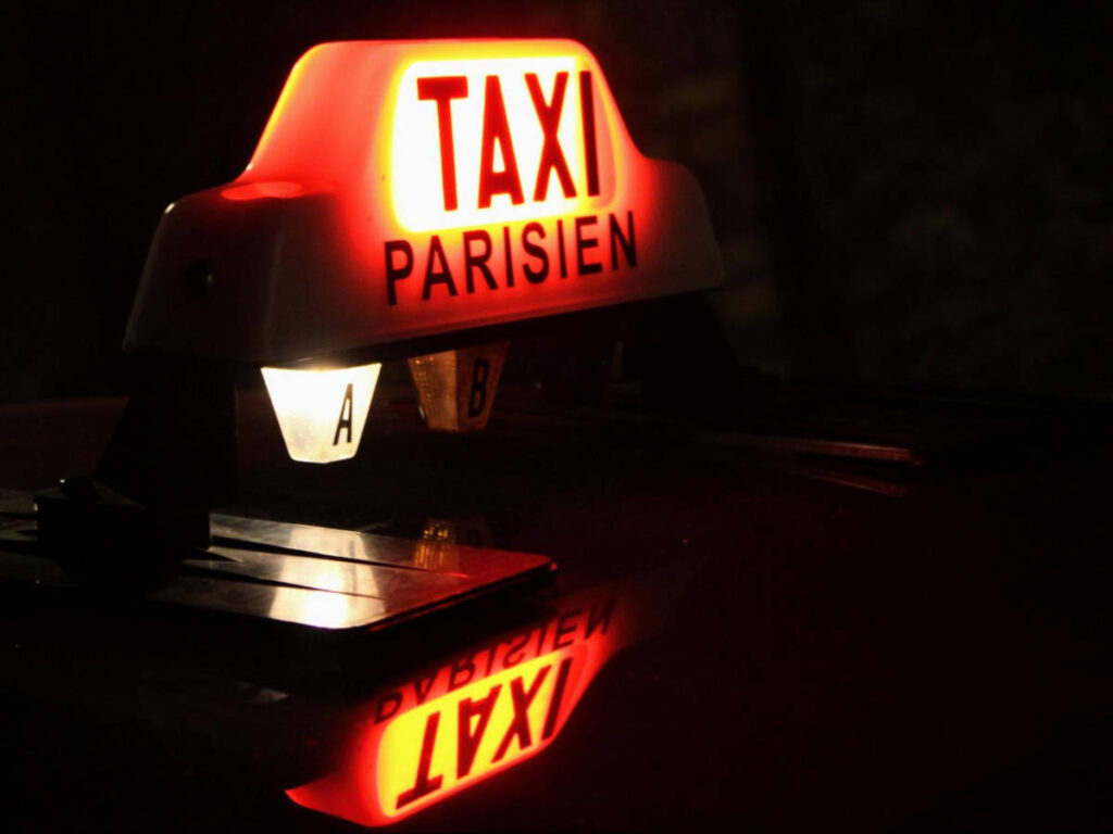 The glowing lights of a taxi at night
