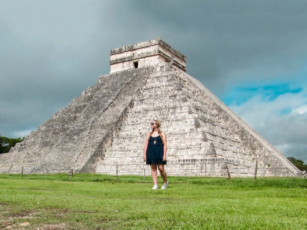 The author, Taylor Herperger posing for a photo with Chichen Itza on her background