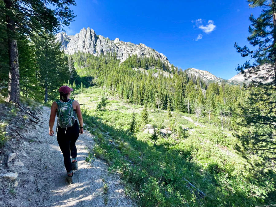 The author, Taylor hiking with a scenic view in Sawtooths