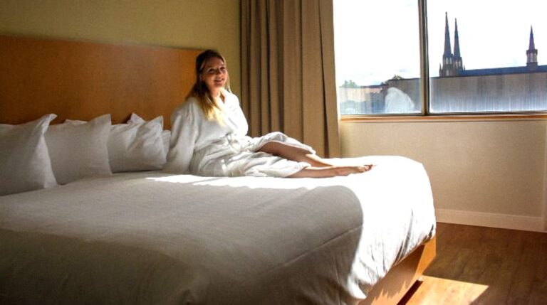 The author sitting on a bed inside the hotel