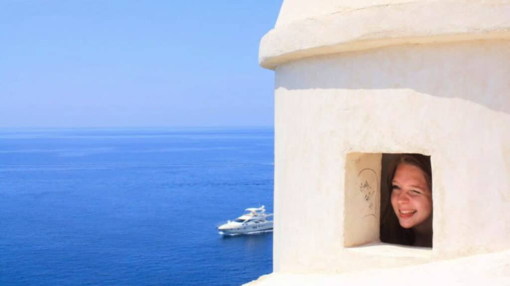The author Taylor Herperger, posing with a wacky face on the walls in Old Town, Dubrovnik