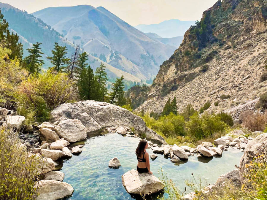 The author, Taylor, sitting on a rock while soaking at Goldbug Hot Springs