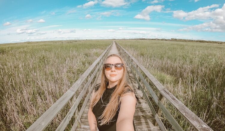 Author Taylor taking a selfie on the wooden pathway at Hecla-Grindstone Provincial Park
