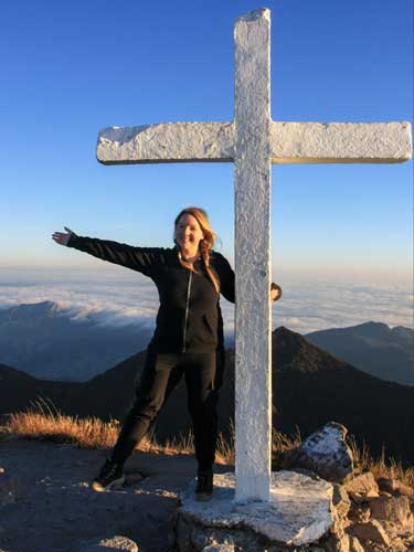 Taylor Herperger posing for a photo at the top of the Volcan Baru