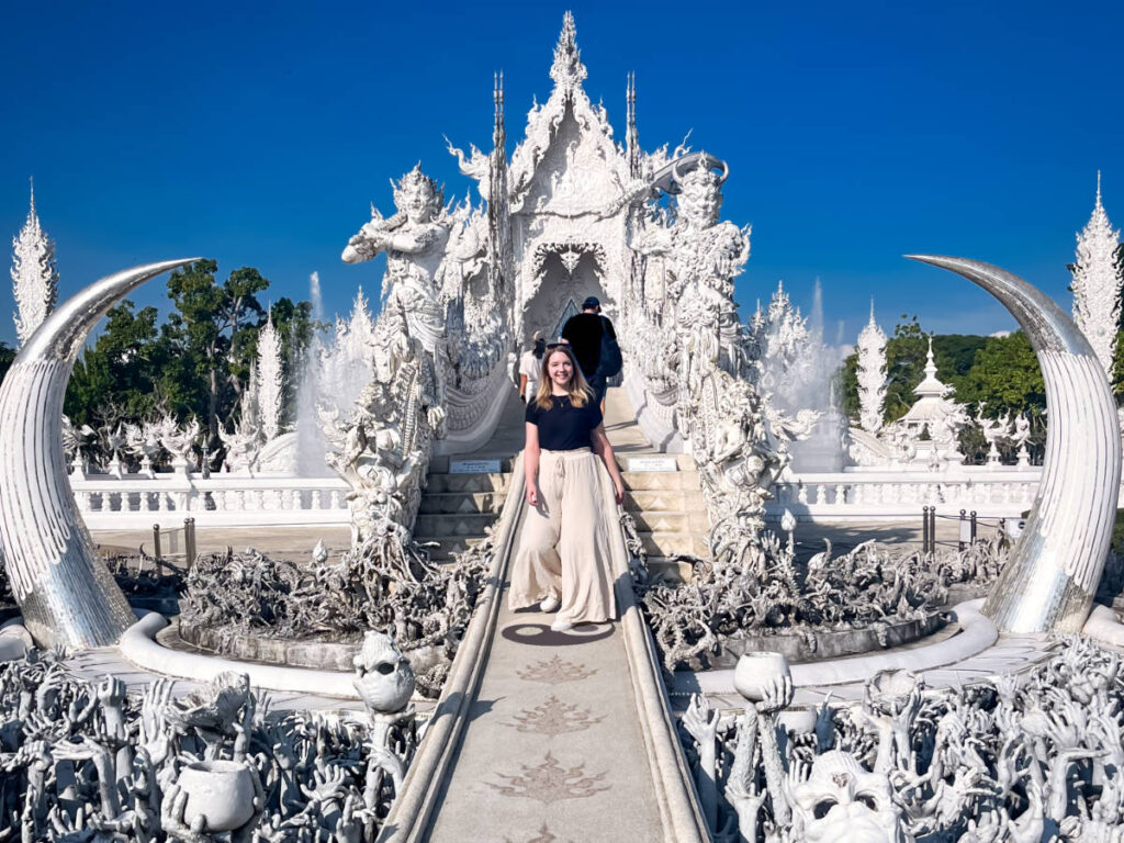 The author Taylor Herperger, walking along the pathway at Wat Rong Khun