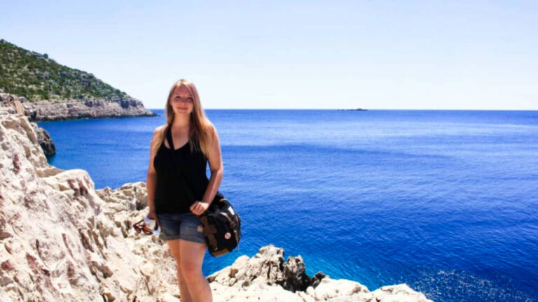 The author Taylor Herperger, posing for a photo on the cliffside in Mljet National Park