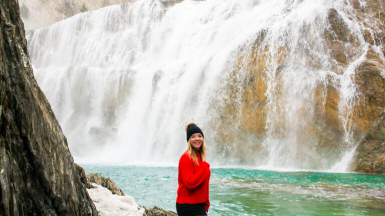 The author Taylor Herperger, posing for a photo in front of the waterfalls in Yoho National Park