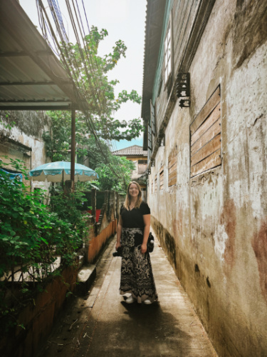 The author Taylor Herperger, posing for a photo at the alleyway in Bangkok
