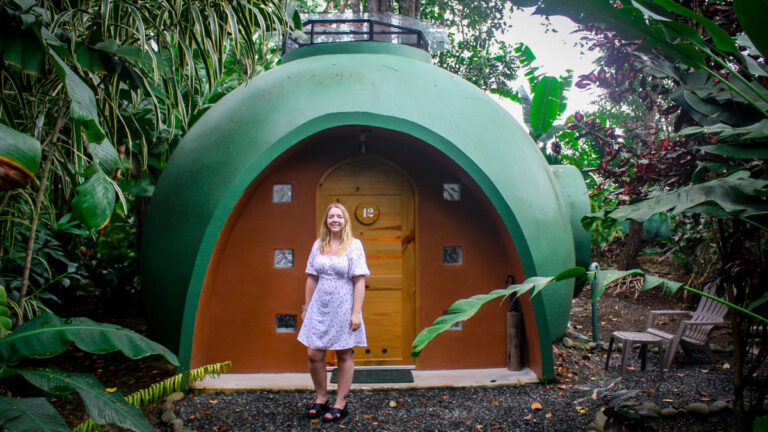 The author Taylor Herperger, standing in front of an Eco Dome at Nowhere in Bocas del Toro