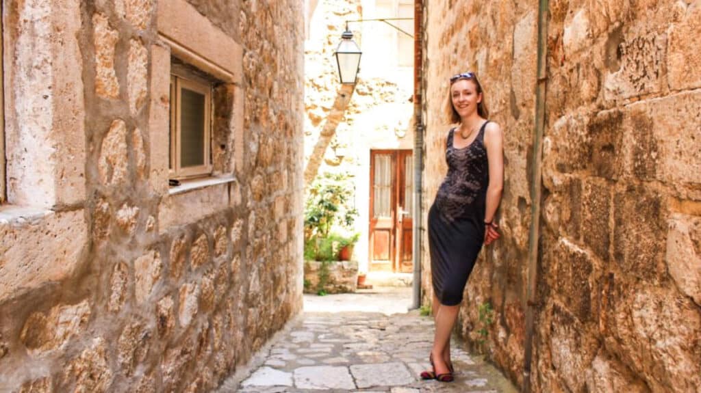 Taylor Herperger's friend, Cailee, posing in one of Dubrovnik’s brick walled side streets
