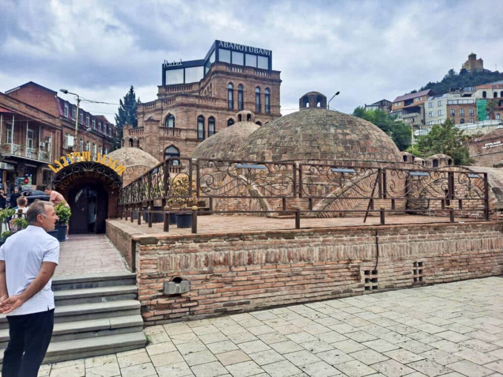 A man enjoying the exterior view of the Royal Bath House