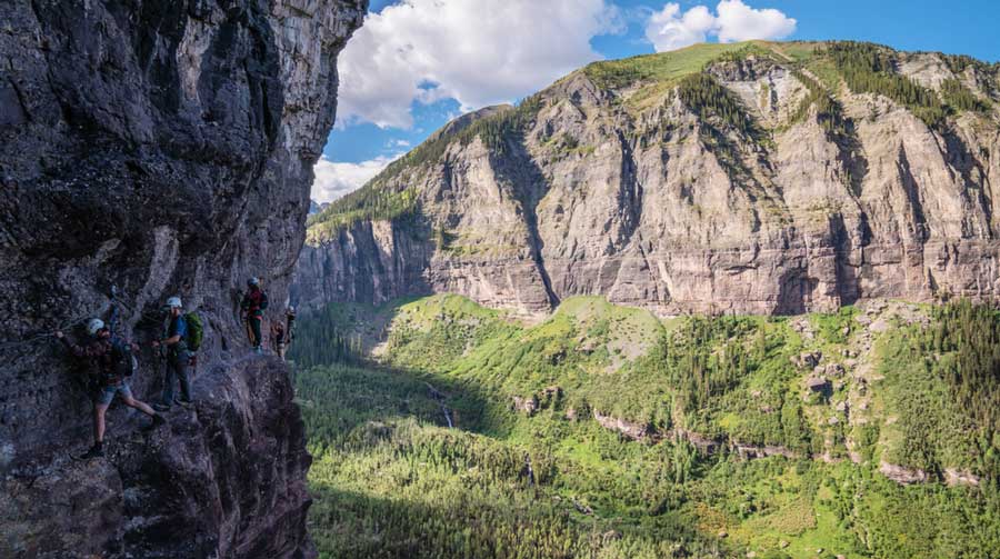Hikers with the overlooking view from Telluride Via Ferrata