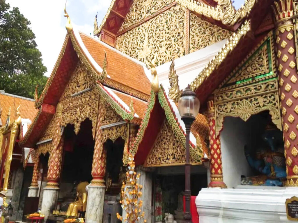 View of the intricate gold exterior of the temple in Chiang Mai