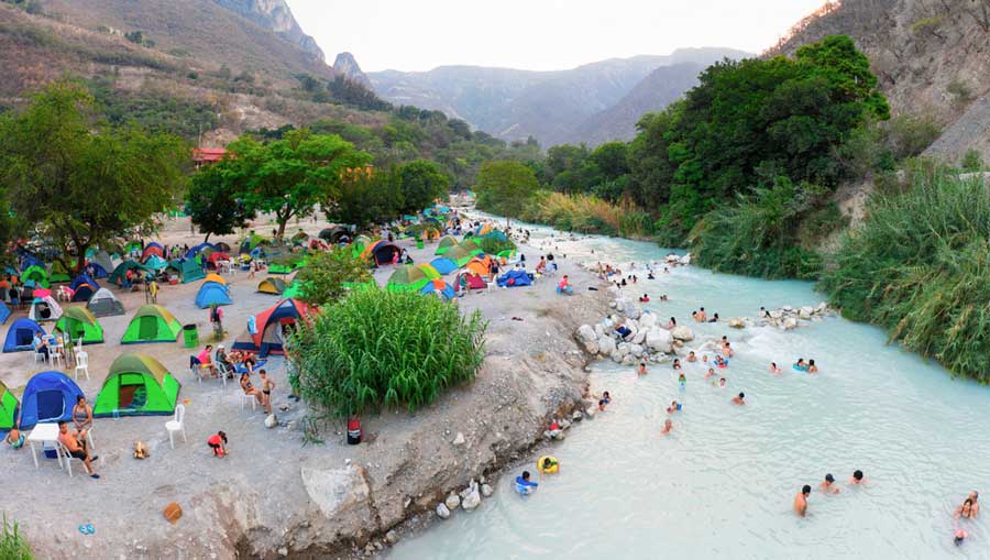 People enjoying their day soaking in the water of Las Grutas de Tolantongo