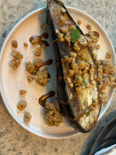 A plate of Teriyaki eggplant with granola crunch served at Bia Lounge
