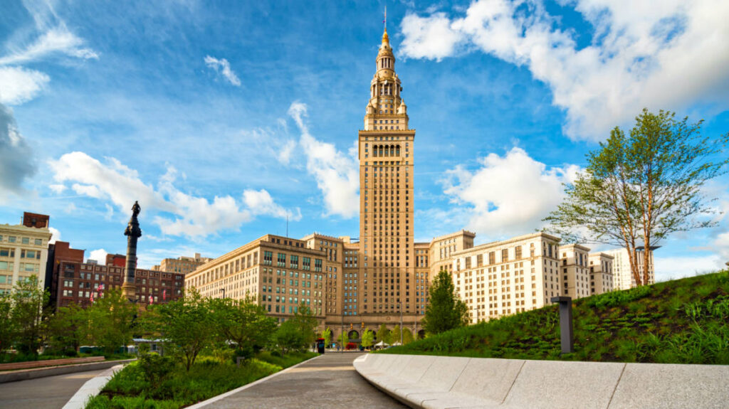 View of the Terminal Tower towering over Cleveland Public Square on a sunny day