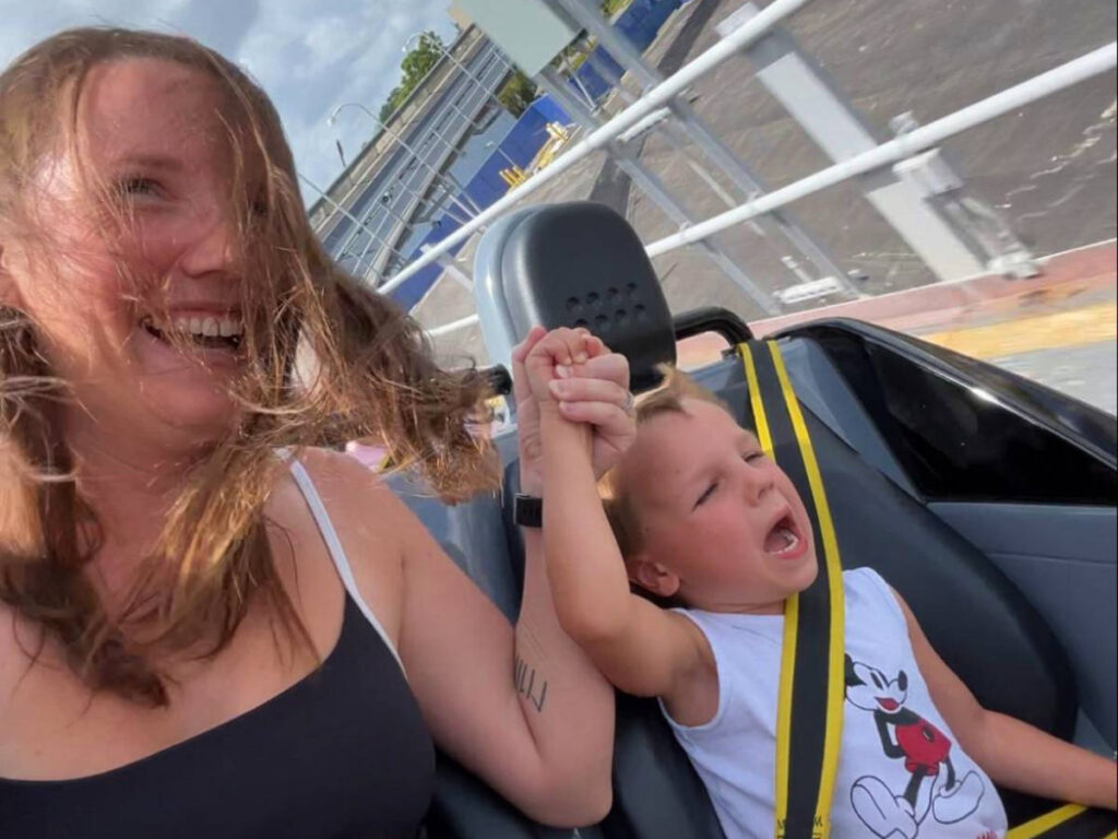 Katie and her son riding the Test Track at EPCOT