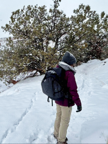 The author, Abigail, testing the Hyperlite 3400 Southwest in the heavy snow in Southern Utah