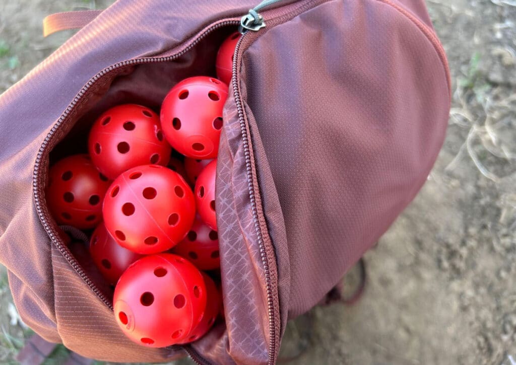 View of plastic red balls inside the Gregory Maven backpack to test the volume