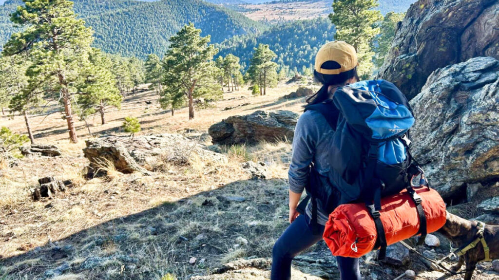 The author, Abigail, admiring the scenic view while carrying the Teton Sports Scout Backpack for a review