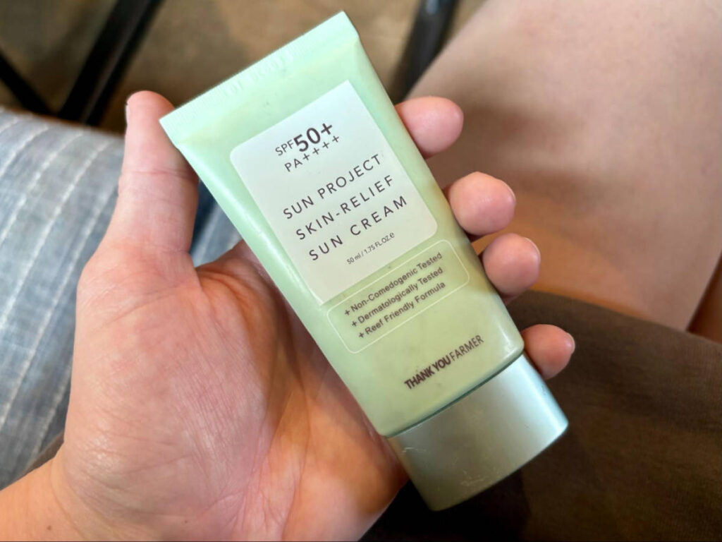 Holding a Thank You Farmer Sunscreen