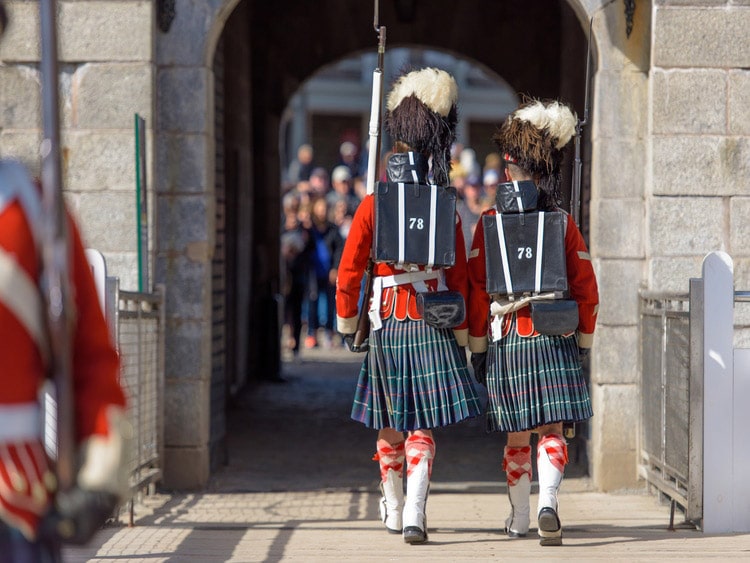 Two personel in red walking