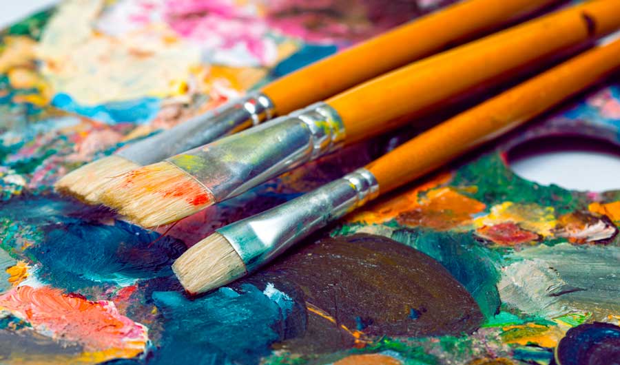 Close up view of paint brushes on a pallette
