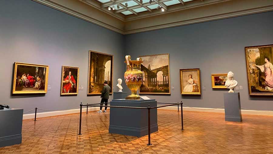 A man admiring a painting inside The Art Institute of Chicago
