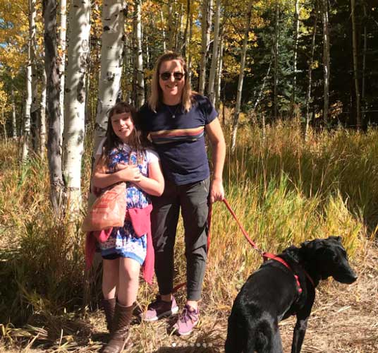The author with her daughter holding their dog