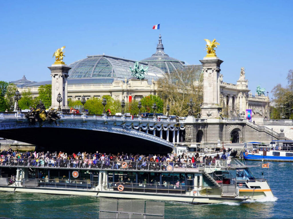 View of The Bateaux-Mouches sailing along the Seine river