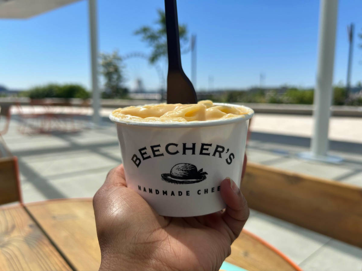 Holding a cup of Beecher’s flagship mac and cheese