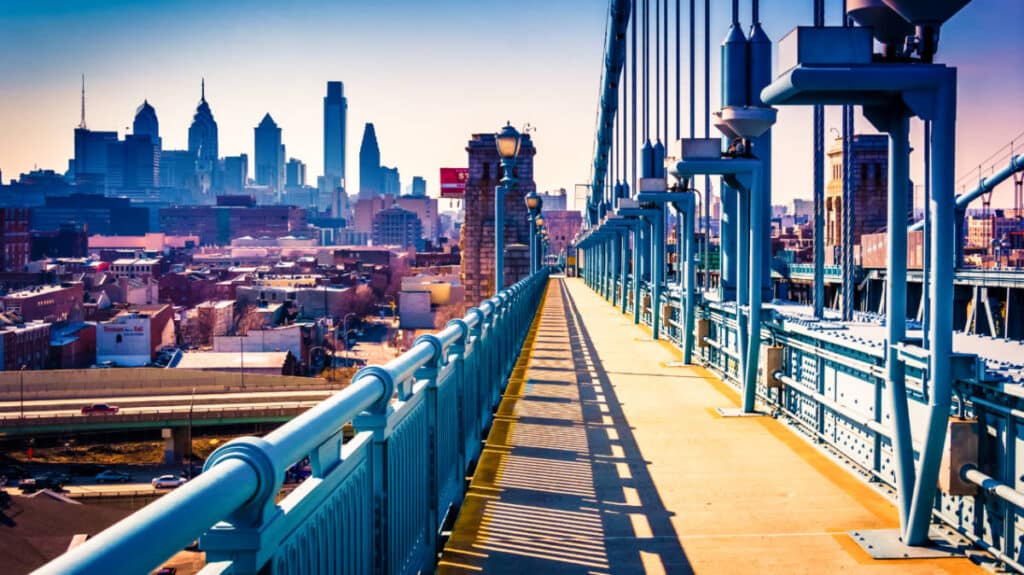 View of the cityscape from the walkway in Ben Franklin Bridge at sunset