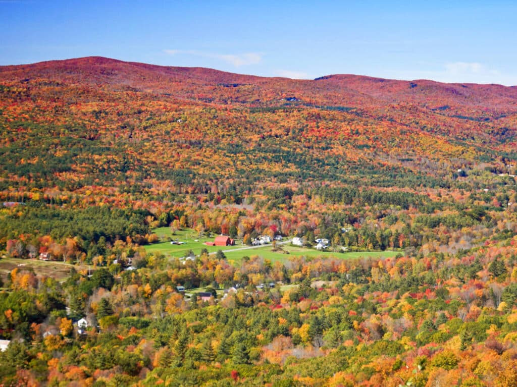 Aerial view of the houses surrounded by fall foliage in the mountain of The Berkshires