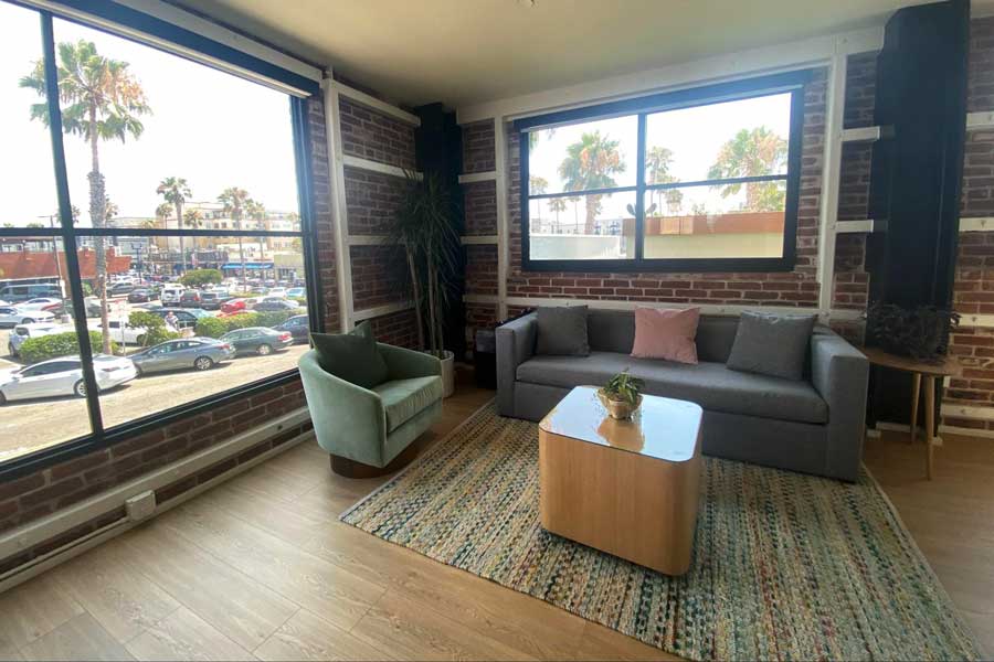 View of a chair and a sofa inside The Brick Hotel