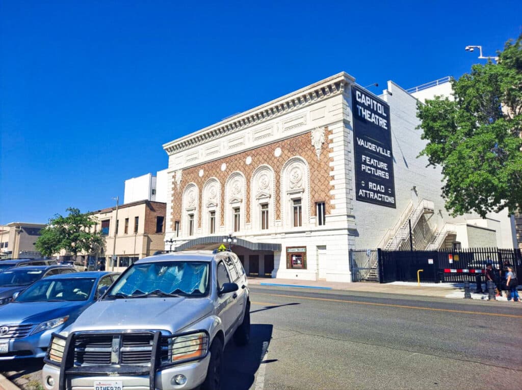 Exterior view of the Capitol Theater and the parked cars across the street