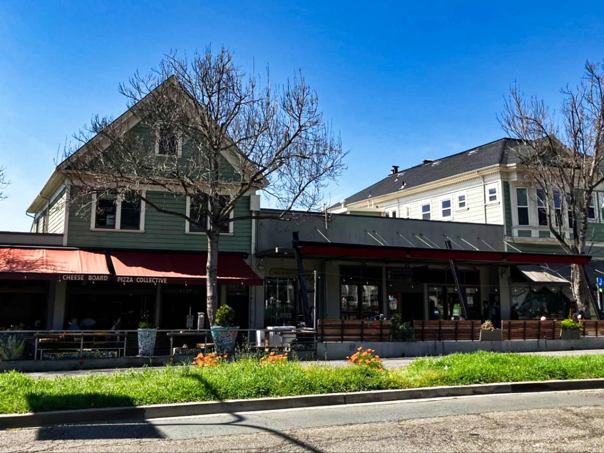 View of the exterior of The Cheese Board Pizza Collective seen from across the street