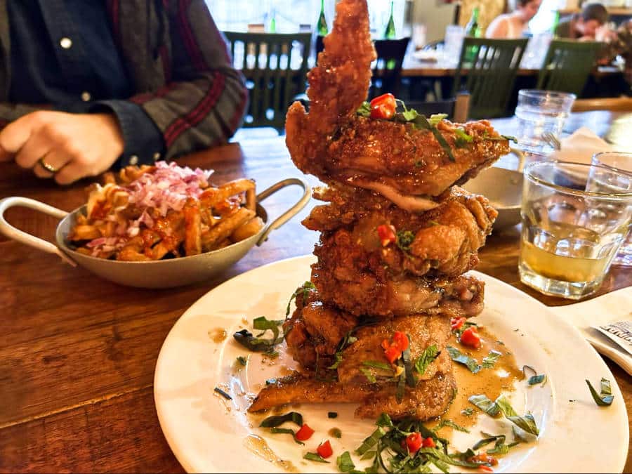 A plate of stacked Chengdu spicy chicken wings