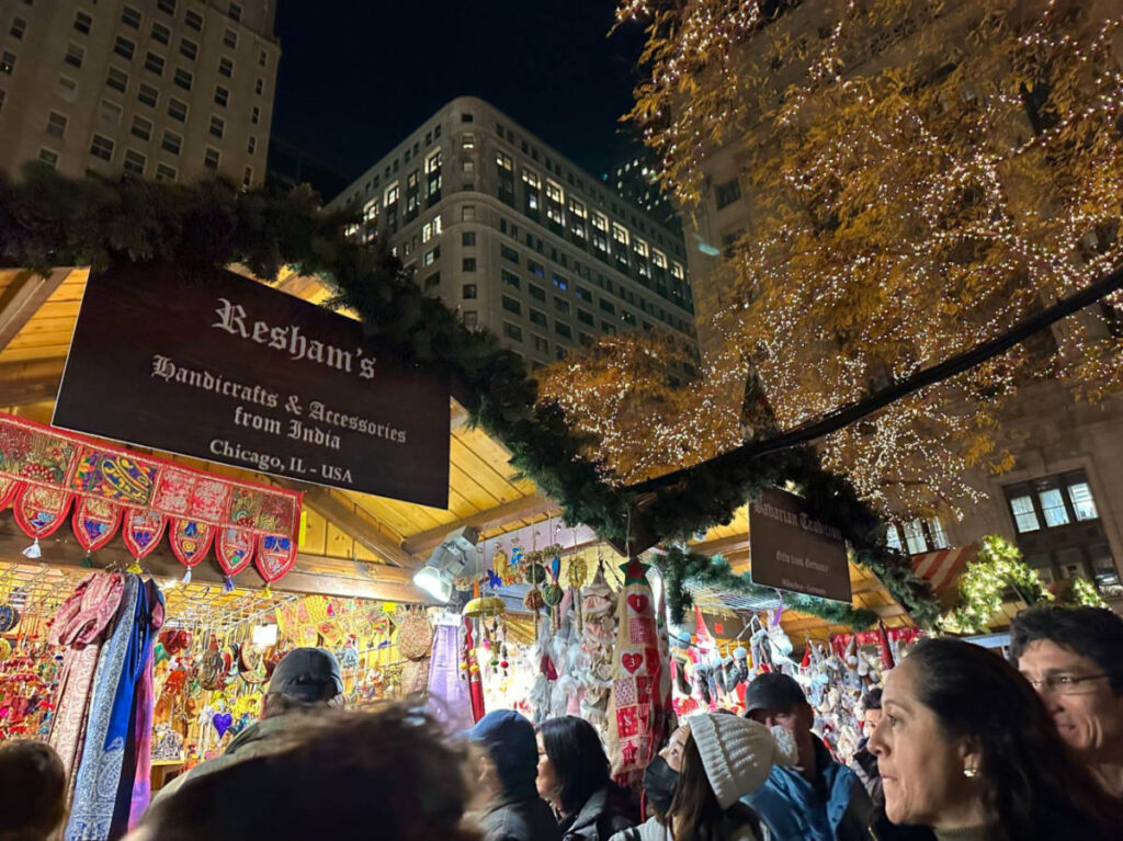 People walking and shopping along the booths at Christkindlmarket
