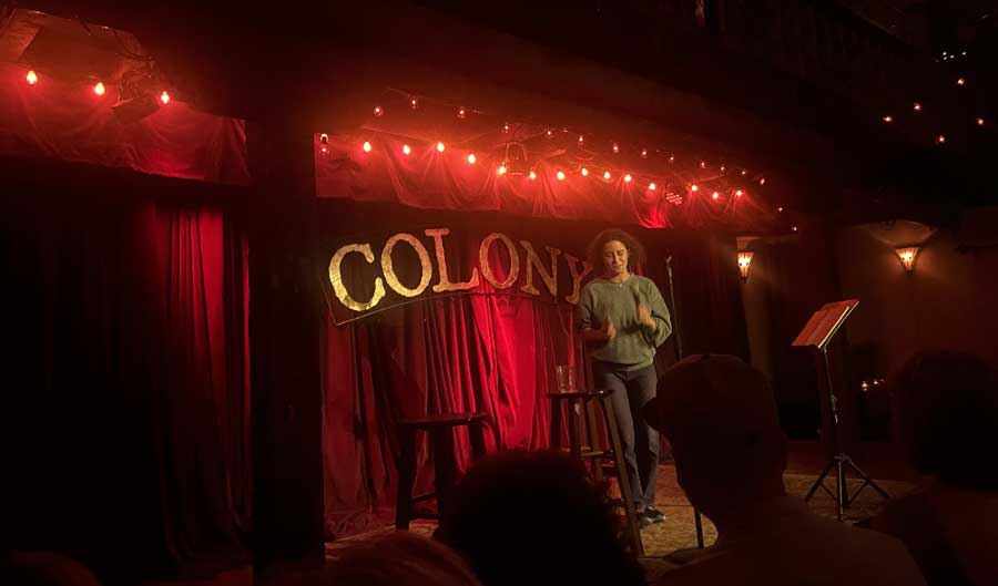 A comedian performing in The Colony in Woodstock