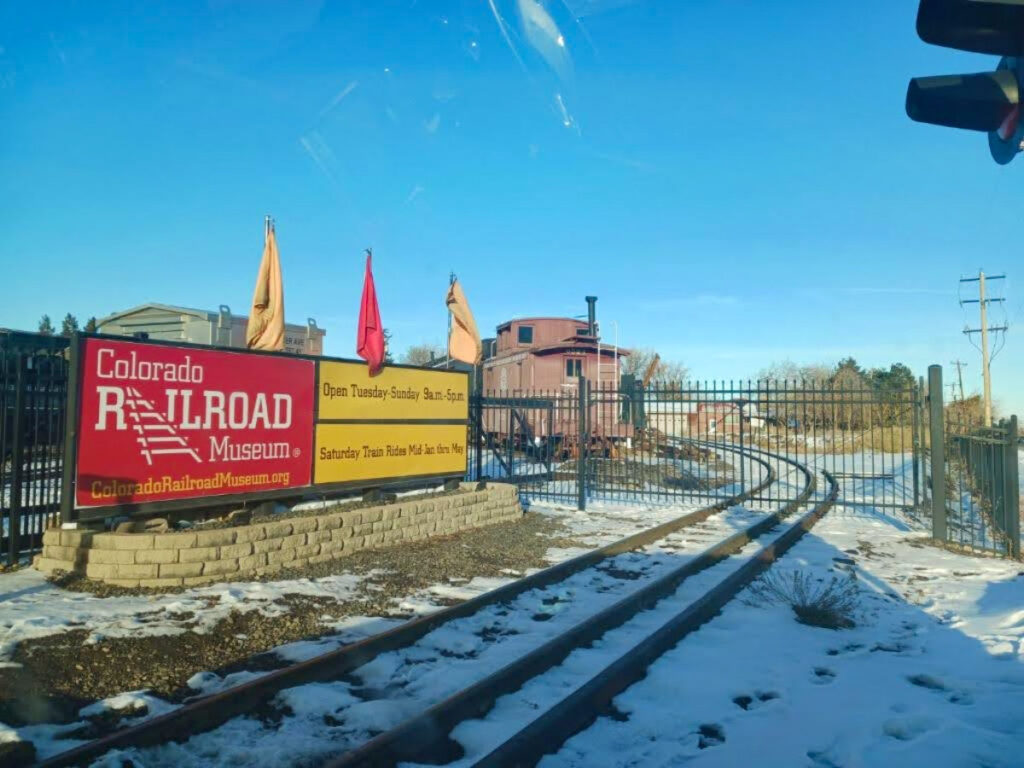 The Colorado Railroad Museum sign amidst a snowy landscape