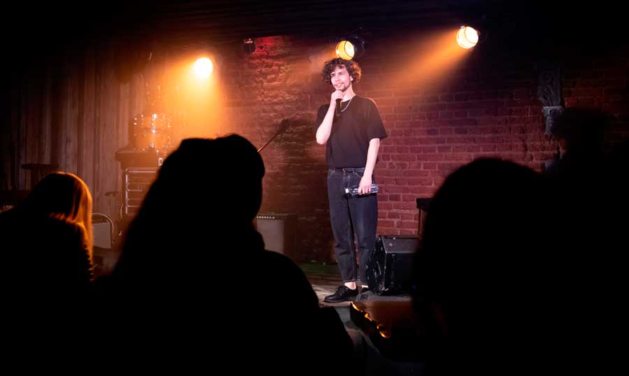 A male comedian performing at The Comedy Store