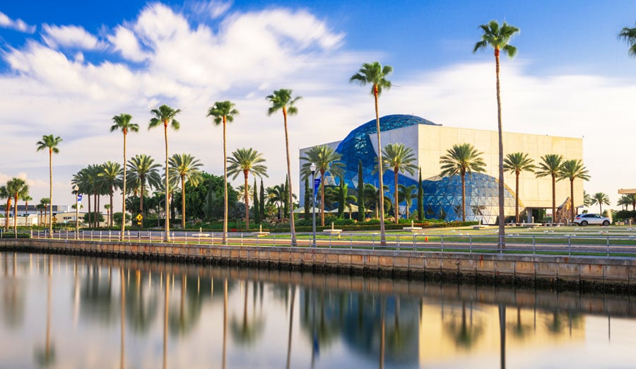 View of The Dali Museum and a line of palm trees across it