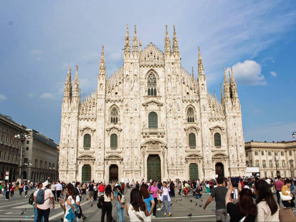 View of the crowd wandering at the Duomo Square with the The Duomo Cathedral in the background