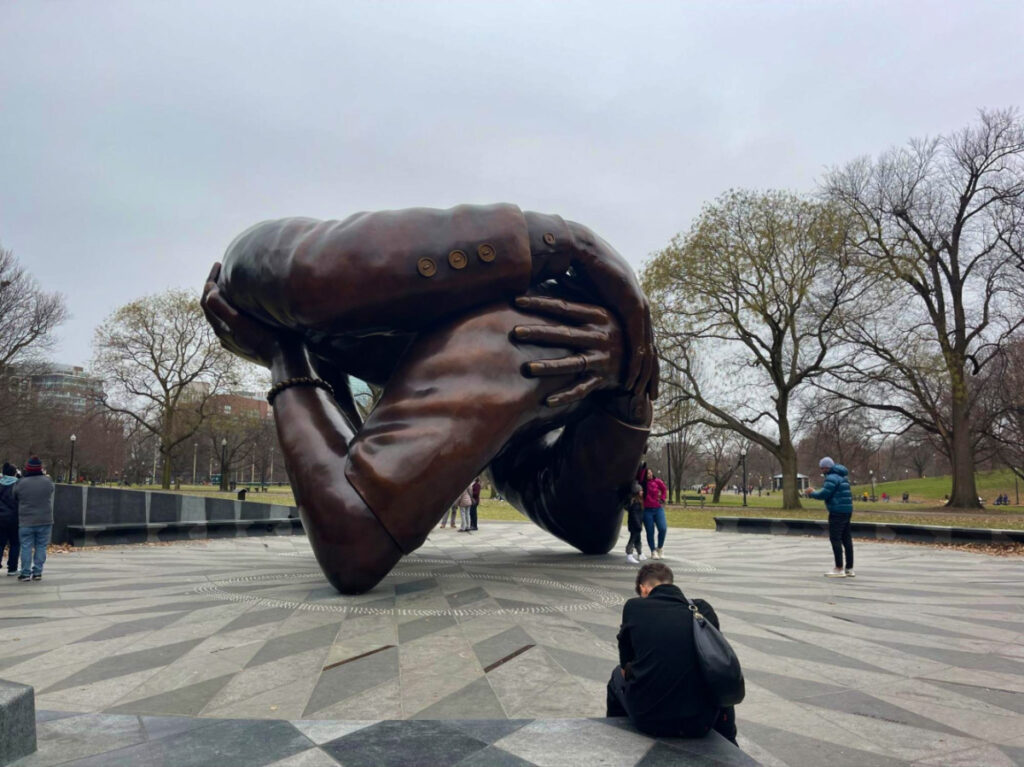 People taking pictures at the Embrace Memorial
