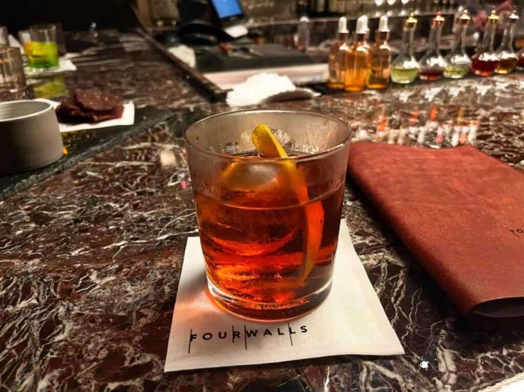 A glass of Negroni on the bar counter at The Four Walls