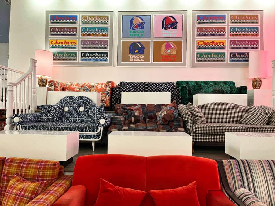View of the colorful wall decorations and couches in the lobby of Hotel Room in The Graduate Nashville